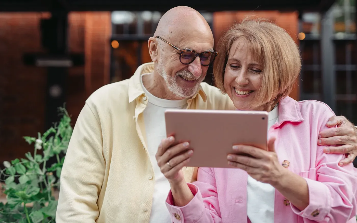 Couple in their seventies reviewing guaranteed issue life insurance options on a tablet